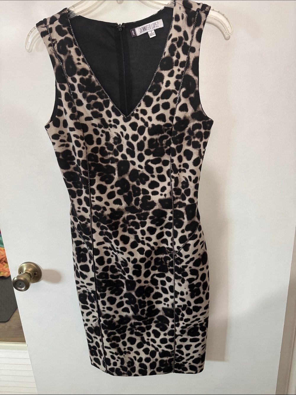 Jennifer Lopez  animal print v-neck dress with tiny chain accent.